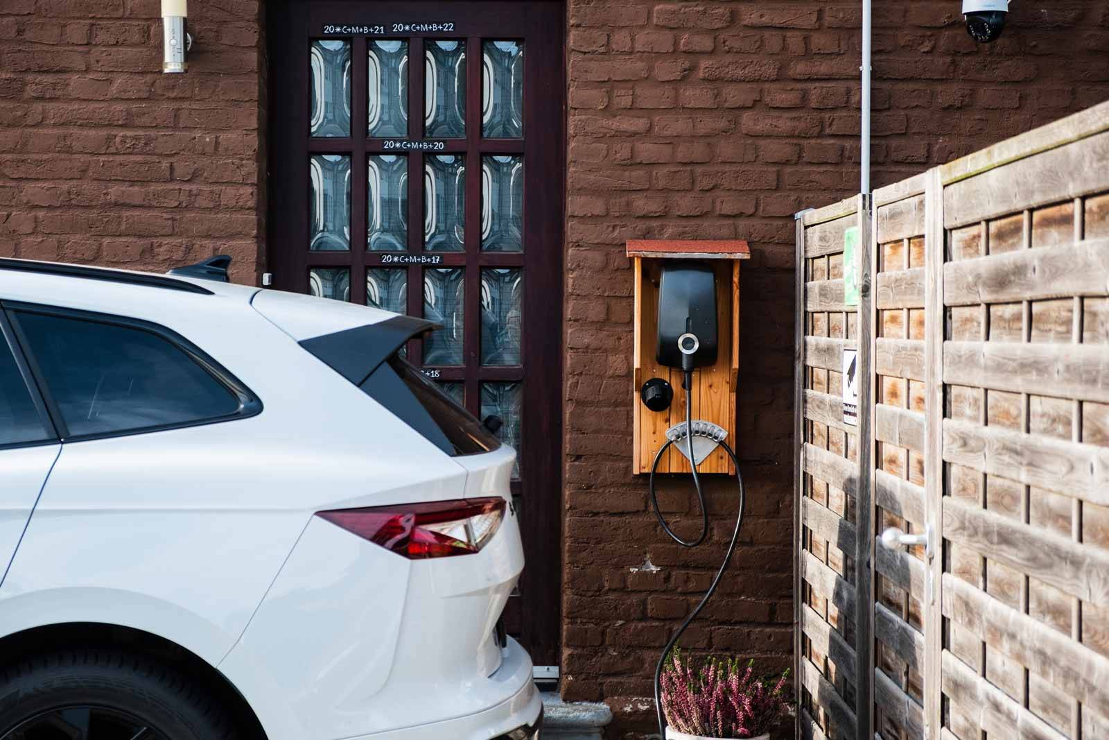 wallbox charges white hybrid car