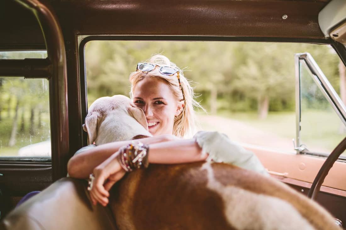 Frau mit Hund im Auto